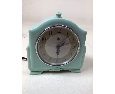 A mid century Smiths turquoise electric clock and a later Juliana clock (untested) together with a wooden table lighter, a bo