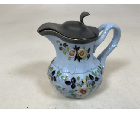 A nineteenth century hand painted ceramic jug with white metal lid. W:13cm x H:11cm
