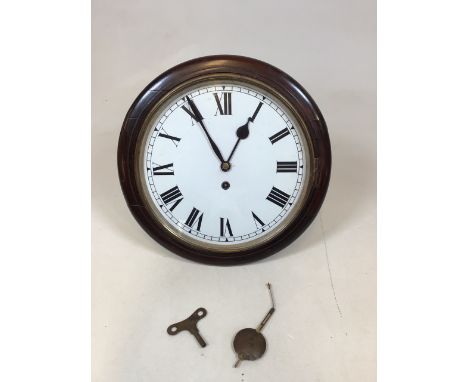 A wooden circular mahogany 12 inch wall clock with pendulum and key. Untested W:15cm x D:13cm x H:15cm