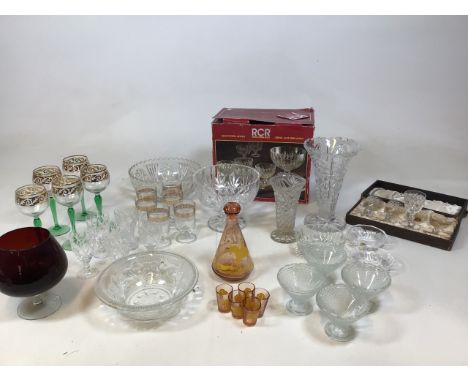 A collection of glass items to include green stem hock glasses, Crystal Sherry glasses, moulded glass bowls, a Crystal desser