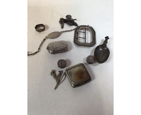 A collection of silver items to include a buckle, snuff box, an identity bracelet and other items 