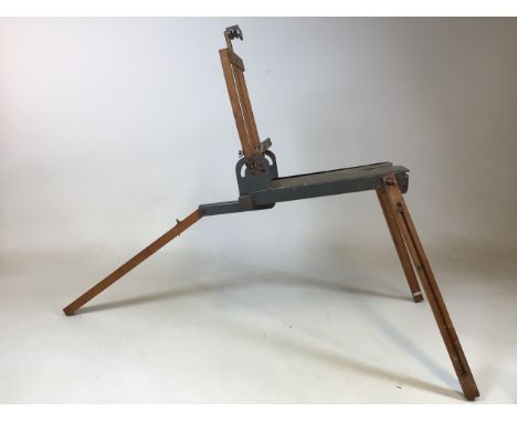 A vintage folding and adjustable easel