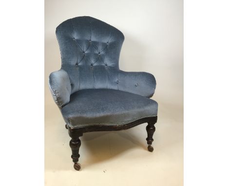 A Victorian ebonised button backed nursing chair with later castors. W:70cm x D:57cm x H:90cm