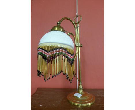 An early 20th Century electric table lamp, with porcelain holophane shade