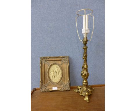 An Italian style cherub plaque and a gilt rococo style table lamp