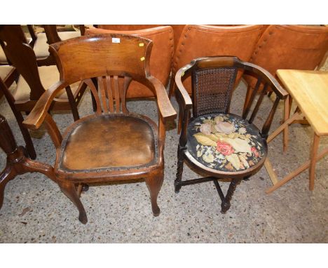An early 20th Century oak framed and leather upholstered desk chair together with a further bow back chair with tapestry seat