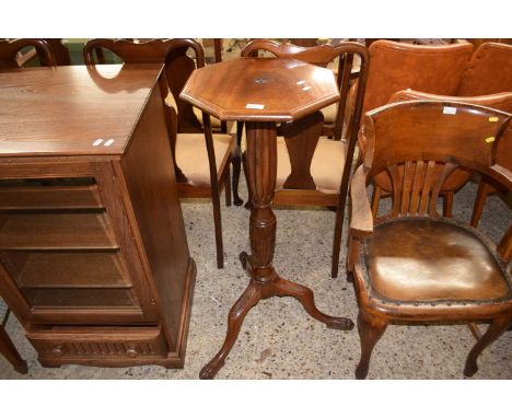 A mahogany jardiniere stand with octagonal top, turned column and tripod base