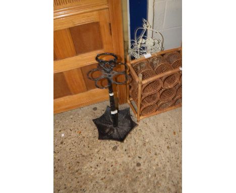 A cast iron umbrella formed stick stand