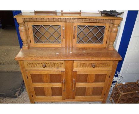 A 20th Century light oak court cupboard with lead glazed doors