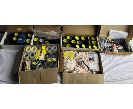 Two Radio controlled model cars in parts together with two boxes of wheels and other accessories 