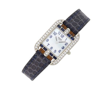 Quartz, rectangular mother-of-pearl dial, black Arabic numerals, curved diamond-set frame, 34 round diamonds ap. .95 ct., 8 r