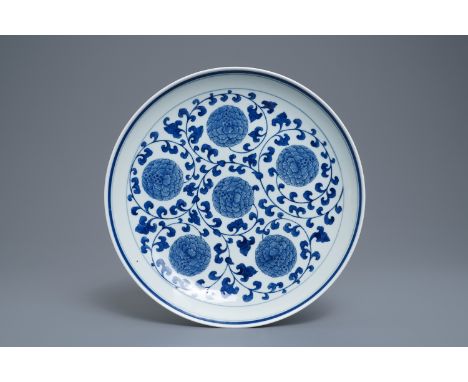 A Chinese blue and white 'peony scroll' dish, marked 'Made in Jingdezhen in 1955' -- Dia.: 32,5 cm  --  Condition reports, hi