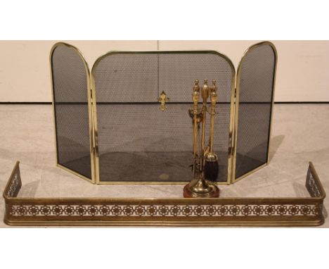 A metal companion set, fireguard and pierced Edwardian fender