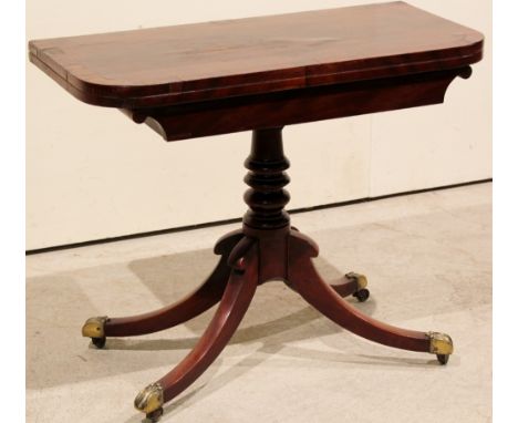 Regency mahogany card table, swivel action, fold-over form. Ring turned column support on 4 splayed legs with original brass 