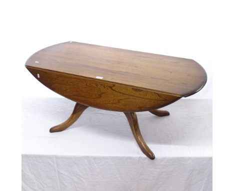 An Ercol Windsor dark elm drop leaf coffee table, on splayed leg base, L122cm, H50cm 