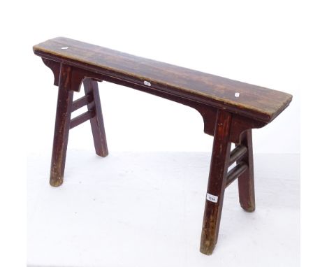 A Chinese stained elm bench stool, L94cm, H52cm 