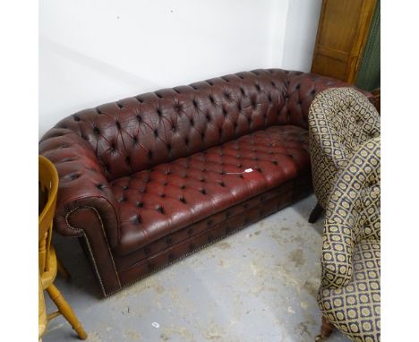 A red leather button-back upholstered Chesterfield settee, L210cm, H75cm, D90cm, seat height 40cm and depth 56cm 