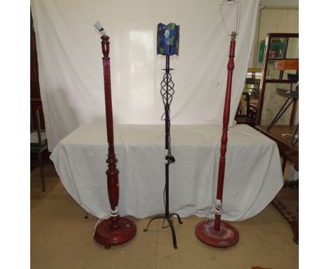 A spiral turned wrought-iron standard lamp, with leadlight dragon design shade, H160cm, and 2 mahogany standard lamps 