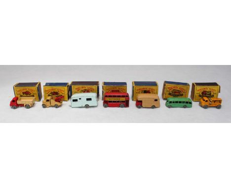 A group of seven Matchbox Moko Lesney vehicles including a London double decker bus, a light green single decker bus, Bedford
