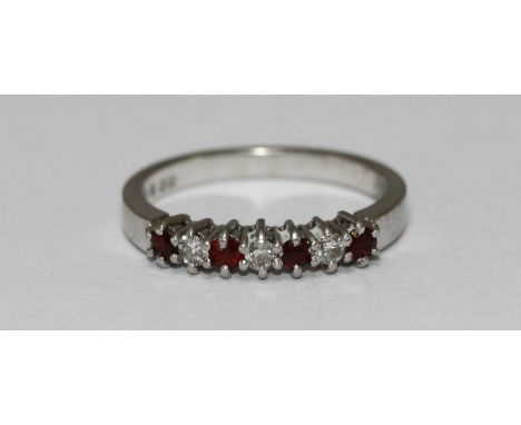 A modern Platinum, diamond and ruby ring, claw-set four rubies and three rbc diamonds, 3.89 grams