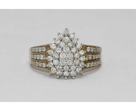 A 9ct gold diamond pear shaped cluster ring, the cluster graduated over three tiers and flanked by a further three rows on bo