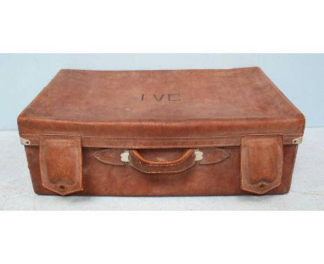 A vintage brown leather travel trunk, the top with initials 'I.V.G' handles to either side and fitted fabric interior. 75cm w