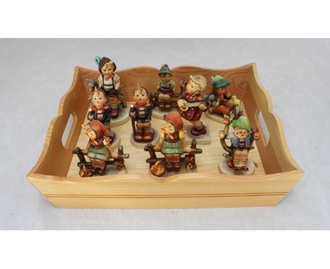 A group of nine Hummel figurines, including 'Little Goat herder' 'Happiness' and 'Just resting' some with minor damage (9)