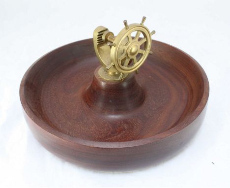 A 20th Century wooden bowl, the centre mounted with a brass nutcracker modelled as a ships wheel.