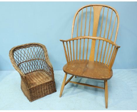 An Ercol elm Windsor chair together with a small child's wicker chair.