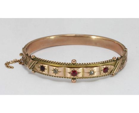 A 9ct gold ruby and diamond set bangle approx weight 12.0grms, hallmarked 1906, (dented)