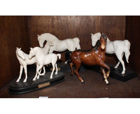 SECTION 33. Three Royal Doulton white horse figure-groups together with a Beswick ceramic horse, (af)