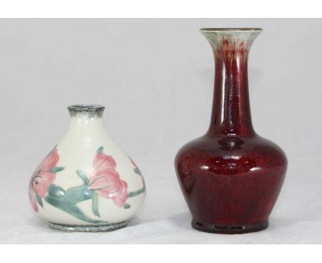 Two Moorcroft Cobridge ceramic vases, one being red flambe in design, the other pink flower, tallest measures 16cm high