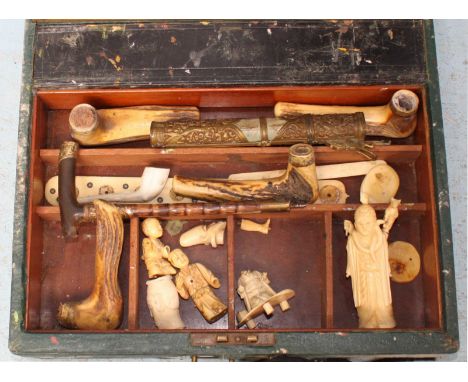 An artist's paint and brush box containing various broken Japanese okimono ivory figures, antler walking stick handles etc