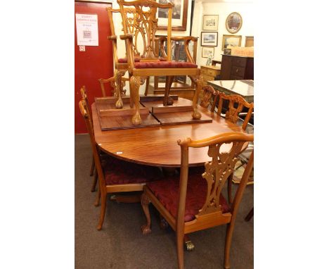 Twin pedestal extending dining table and two leaves together with a set of eight Chippendale style chairs including pair carv