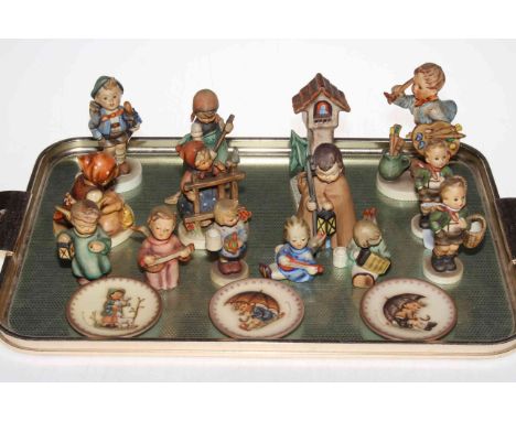 Collection of fourteen Hummel figures and three small plates.