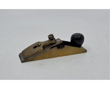 A miniature brass cabinet maker's edge plane, with chisel type cutter, sole 6cm x 1 1/4cm.