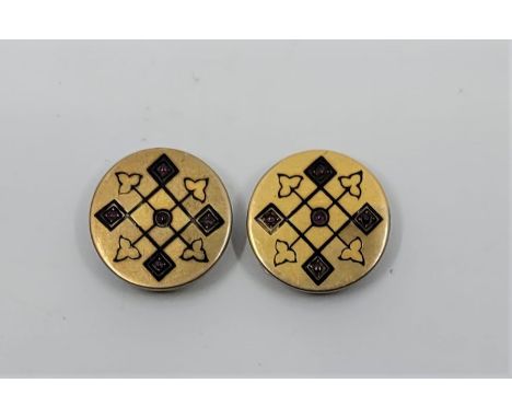 A pair of precious yellow metal, black enamel and cabochon ruby set circular cufflinks, diameter 19mm (yellow metal assessed 
