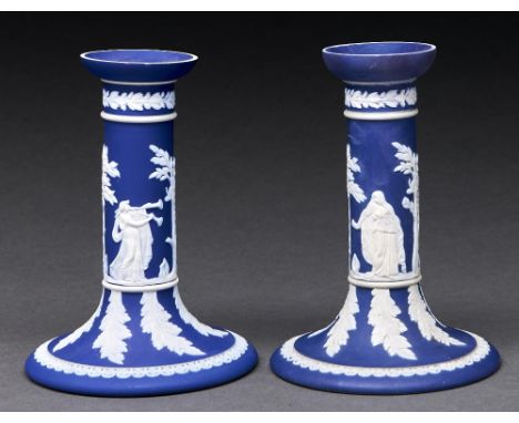 A pair of William Adams & Co dark blue jasper dip candlesticks, c1900, sprigged with classical figures and stiff leaves, 15cm