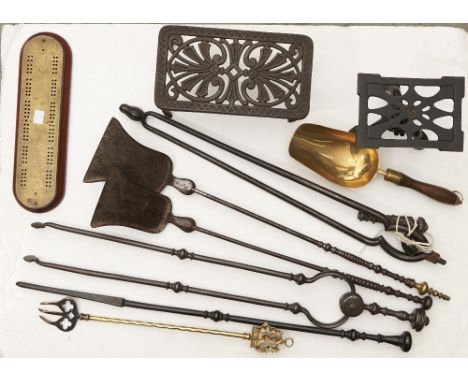 A brass topped wooden cribbage board, oval, together with brass toasting fork, two pierced iron trivets and two Georgian stee