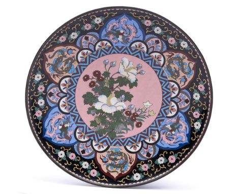 A Japanese cloisonne enamel dish, Meiji period, the central pink ground medallion of flowers in zigzag surround, the lappet b