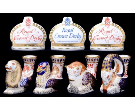 Four Royal Crown Derby candlestick paperweights,&nbsp;no stoppers&nbsp;and three Royal Crown Derby crown name stands, gilt st