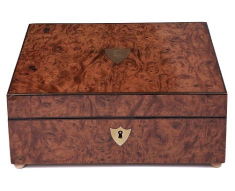 A Charles X burr maple work box, the lid inset with a brass shield engraved with monogram, the red painted fitted interior wi