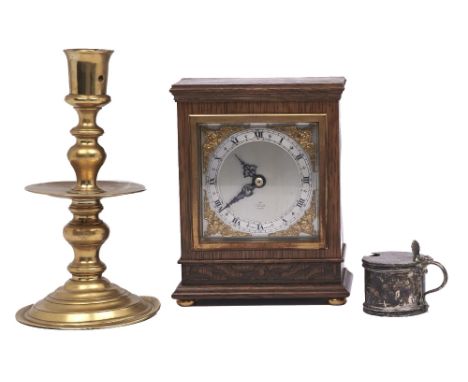 A Dutch brass heemskirk candlestick, 19th c,&nbsp; 20cm h, an Elliott oak mantel timepiece and a silver mustard pot (3)  Good