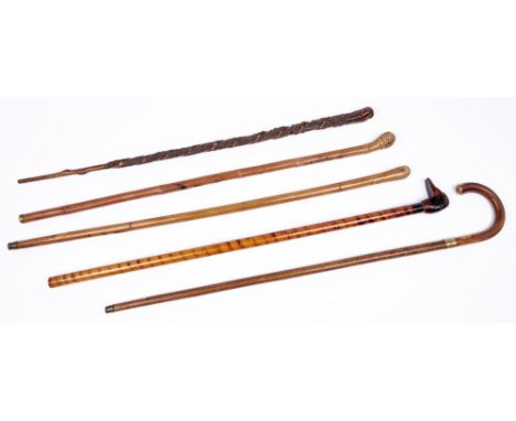 A Japanese bamboo cane, carved with apes, three various other wood canes and a walking stick, early 20th c, various lengths (
