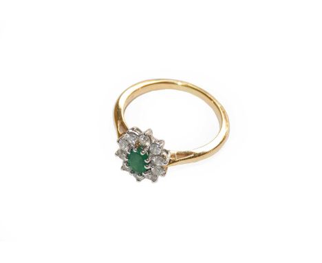 An 18 carat gold emerald and diamond cluster ring, finger size PCondition report: Gross weight 3.9 grams.