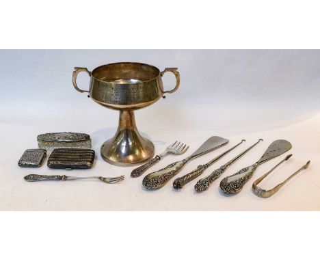 A silver two-handled cup; a pair of sugar tongs; a vesta case; a cigarette box; and a collection of button hooks and show hor