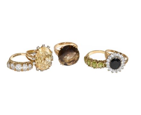 A smoky quartz ring, stamped '18CT', finger size M; another gem-set ring stamped '18CT', finger size K1/2; a 9 carat gold per