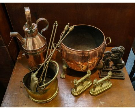A large collection of Victorian brass and copper items including a large milk jug, coal bucket, coal helmet, footman, fire to