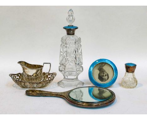 A silver and enamel hand mirror, photo frame, dressing table bottle and atomiser, a set of six silver teaspoons and a pair of