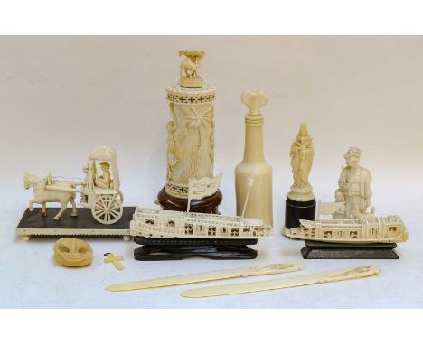 An early 20th century carved ivory lamp base, an Indian ivory bullock cart circa 1920, two 19th century carved ivory boats, a